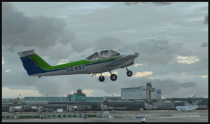 Piper Tomahawk PA-38 airborne from runway 28 at the Montreal Pierre-Elliott-Trudeau international airport, with the Montreal terminal in the background. (FSX)