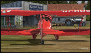 A WACO aircraft is parked near the Bear Gulch Aviation hangar, WA38