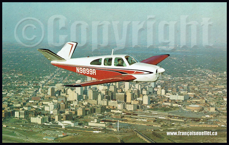 A Beechcraft P35 N9899R with passengers over Dallas, Texas, on an aviation postcard