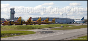 Nav Canada control tower with, in the foreground, several CL-215 and Cl-415, a Nav Canada Challenger, and an Air Transat Airbus at the Quebec Jean-Lesage international airport (CYQB).