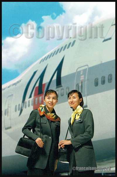 Two Japan Asia Airways flight attendants, with a Boeing 747 in the background, on an aviation postcard