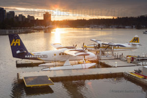 Harbour Air Twin Otter floatplane C-GQKN and Turbo Otter floatplane C-FODH in the sunset in the Port of Vancouver during summer 2016