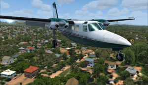 The Shrike Commander 500S over the houses near the Port Moresby Jacksons airport.