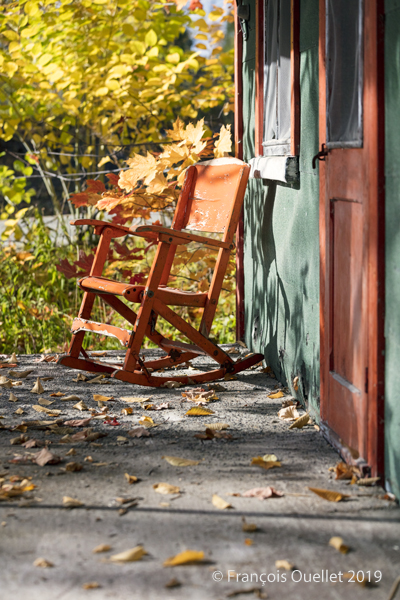 Chair and house in Autumn in Val-Bélair.