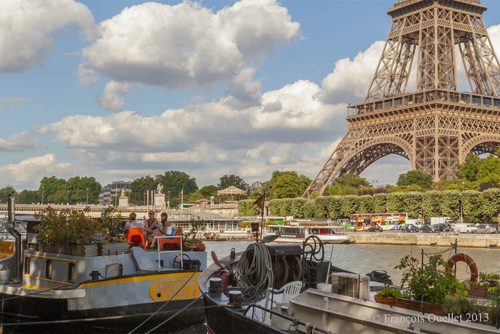 Parisians chat in the shadow of the Eiffel Tower