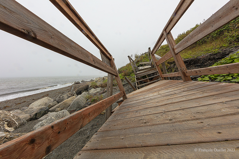 The movement of ice broke these wooden stairs on the beach in Matane, Québec 2023